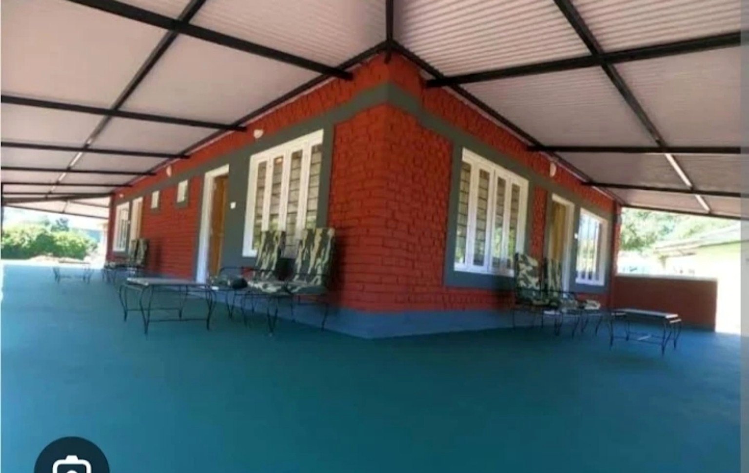 Covered verandah and outdoor seating at Runnel View homestay in Masinagudi